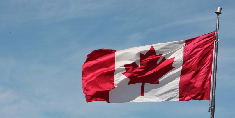 Canadian Flag Against Blue Sky.png